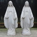 A pair of reconstituted stone figures of