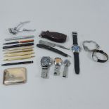 A collection of wristwatches and pens et