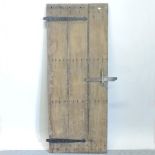 An antique oak plank door, with an iron