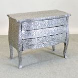 An embossed white metal chest of drawers