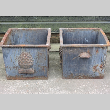 A pair of cast iron garden planters, eac