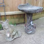A garden statue of a fox, together with