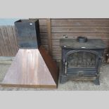 A cast iron wood burner, 61cm, together