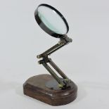 A magnifying glass, on a wooden base, ap