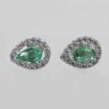 A pair of 18 carat gold emerald and diam
