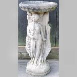 A reconstituted stone figural bird bath,