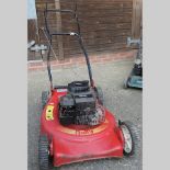 A Rally red petrol lawnmower