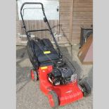 A Champion red petrol lawnmower