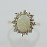 A 9 carat gold opal and diamond dress ri