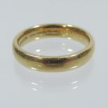 An 18 carat gold wedding band