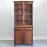 A Victorian mahogany glazed cabinet book