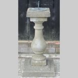 A reconstituted stone sun dial, 75cm tal