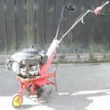 An Axtra red petrol driven rotovator