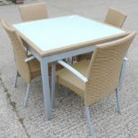 A rattan and glass top square garden tab