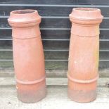 A near pair of terracotta chimney pots,