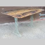 A wooden garden table, on a green painte