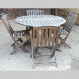 A hardwood circular folding garden table