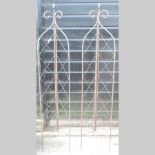 A pair of brown painted metal garden spi