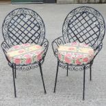 A pair of black painted iron garden armc