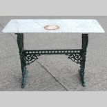 A Victorian marble top table, on a green