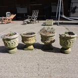 A pair of reconstituted stone planters,