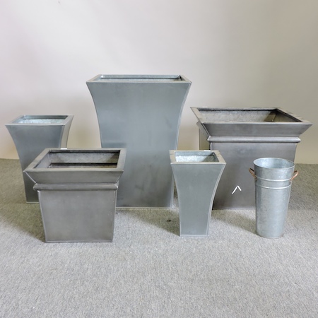 A metal planter, together with five others,