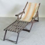 A hardwood and canvas garden deck chair,