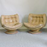 A pair of 1970's cream leather upholstered button back swivel chairs