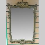 An ornate gilt painted wall mirror,