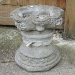 A reconstituted stone bird bath,