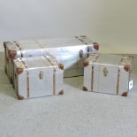 A set of three graduated steel and wooden bound travelling trunks,