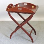 A reproduction mahogany butlers tray, on stand,