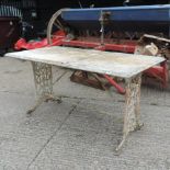 A Victorian white painted cast iron garden table, with a white marble top,