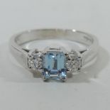 An 18 carat white gold aquamarine and diamond three stone ring,