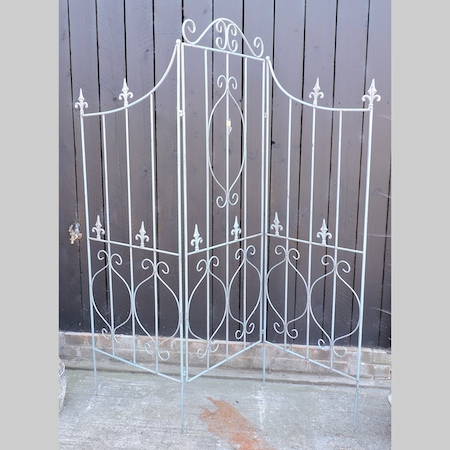 A blue painted metal three fold screen,