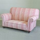 A 1920's pink striped upholstered two seater sofa,