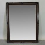 A large modern carved wall mirror,