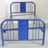 A blue painted metal double bedstead,