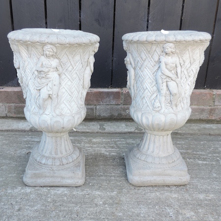 A pair of reconstituted stone planters,