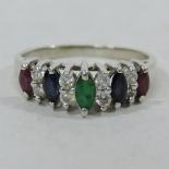 A 14 carat white gold unmarked ring, set with emeralds, rubies, sapphires and diamonds,