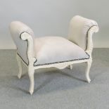 A cream painted and upholstered window seat,