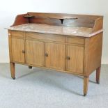 A Victorian mahogany and inlaid washstand, with a marble top,