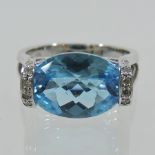 A 14 carat white gold diamond and topaz ring,