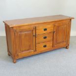 A large grained pine sideboard,