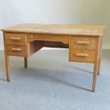 A 20th century light oak desk,