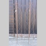 A pair of brown painted metal garden spires,