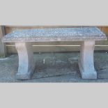 A reconstituted stone garden bench,