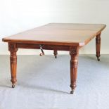 A late Victorian walnut wind out extending dining table,