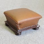 A Victorian brown upholstered footstool,