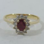 An unmarked gold ruby and diamond cluster ring,